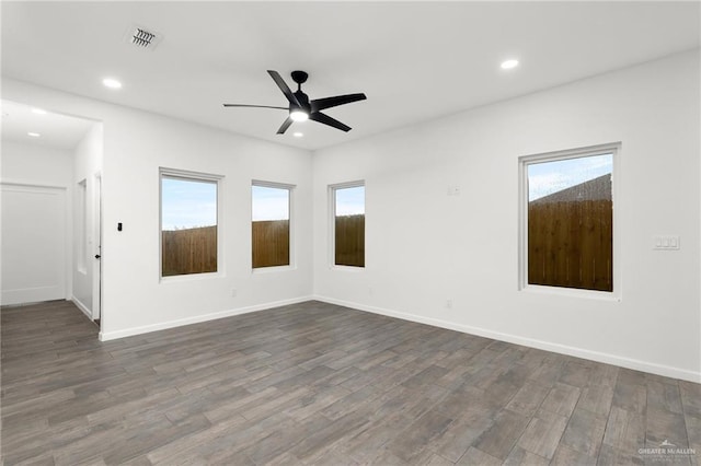 unfurnished room featuring ceiling fan and dark wood-type flooring