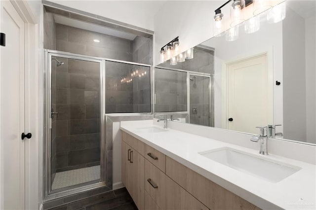 bathroom with wood-type flooring, vanity, and a shower with shower door