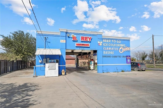 view of building exterior featuring fence