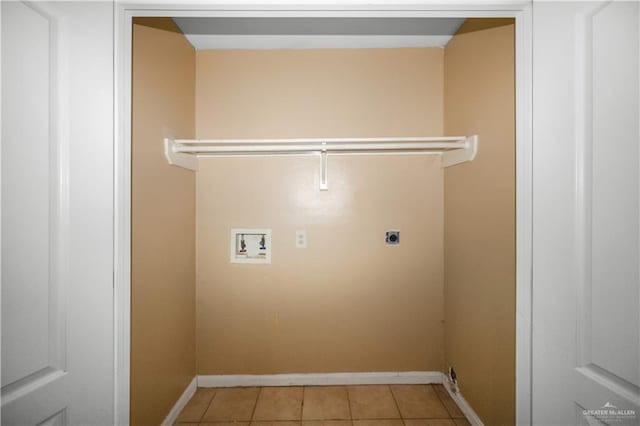 clothes washing area featuring washer hookup, light tile patterned floors, hookup for an electric dryer, laundry area, and baseboards