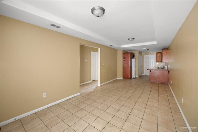 unfurnished living room featuring visible vents, baseboards, and light tile patterned floors