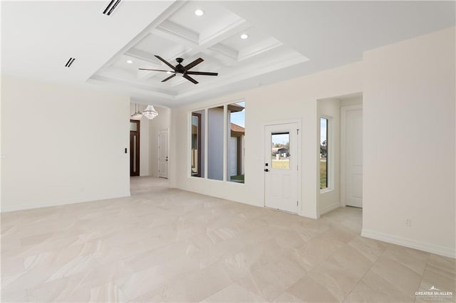 unfurnished living room with ceiling fan, beamed ceiling, and coffered ceiling