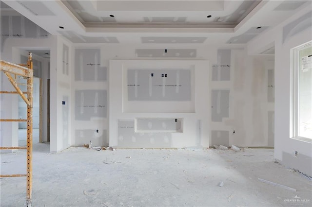 unfurnished living room with a tray ceiling