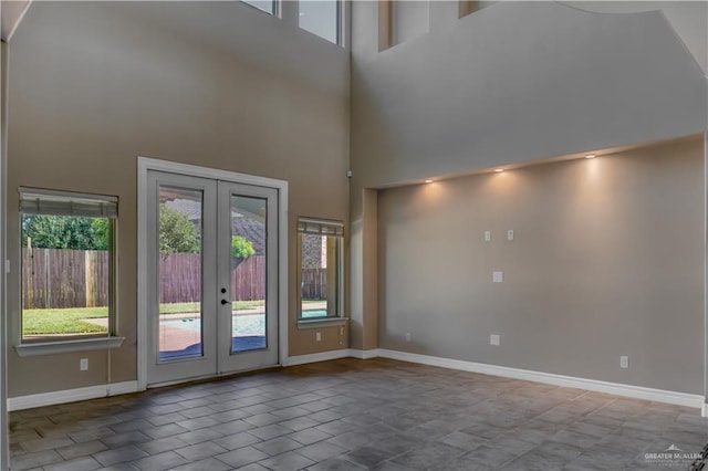 interior space with a high ceiling and french doors