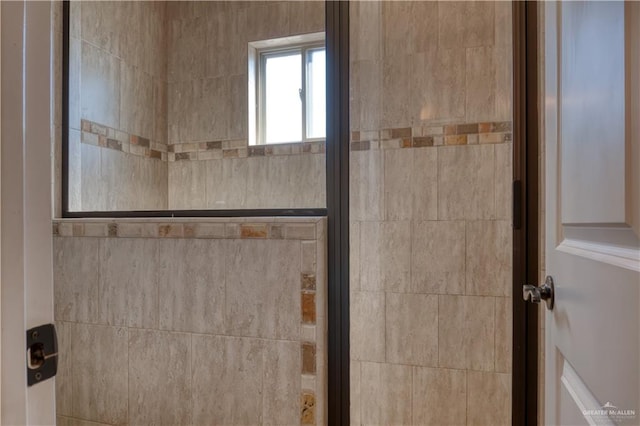 bathroom with a shower with door