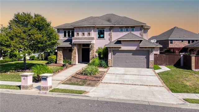 view of front of home with a yard and a garage