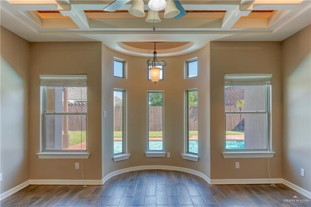 doorway with a wealth of natural light, dark hardwood / wood-style flooring, and coffered ceiling