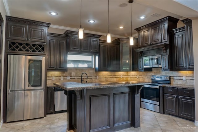 kitchen featuring appliances with stainless steel finishes, dark stone counters, decorative light fixtures, and crown molding