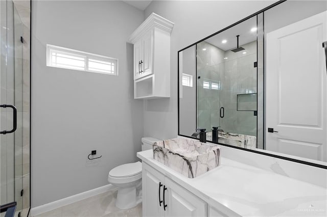 bathroom featuring a shower with door, vanity, and toilet