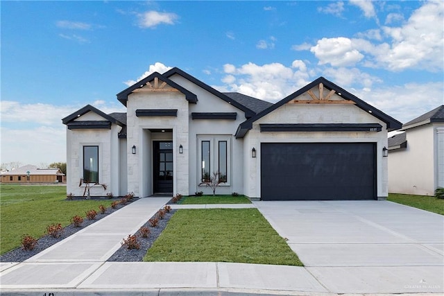 view of front of house featuring a garage and a front yard