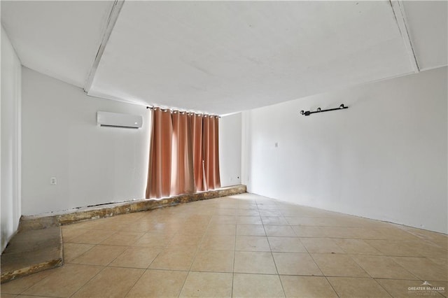 empty room with light tile patterned flooring and an AC wall unit
