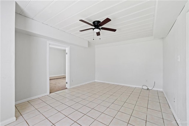 unfurnished room featuring ceiling fan, baseboards, and light tile patterned floors