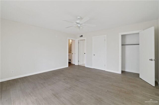 unfurnished bedroom with baseboards, a ceiling fan, and wood finished floors