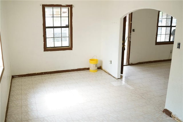 5909 S Kountry Loop, Mission, TX 78574 - spare room featuring arched walkways, baseboards, and tile patterned floors