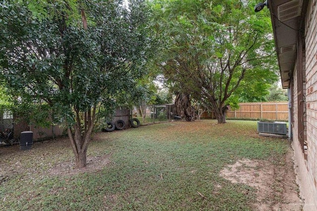 view of yard featuring central air condition unit