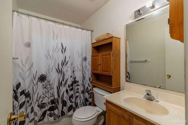 bathroom with a shower with curtain, vanity, a textured ceiling, and toilet