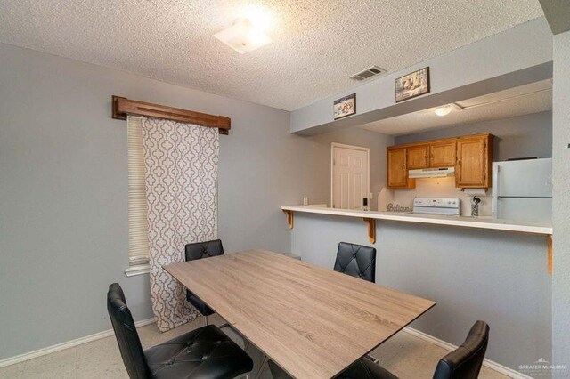 dining area with a textured ceiling