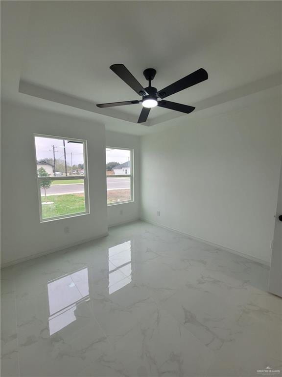 unfurnished room with a tray ceiling