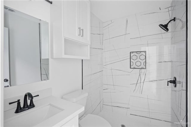 full bath with toilet, a marble finish shower, and vanity