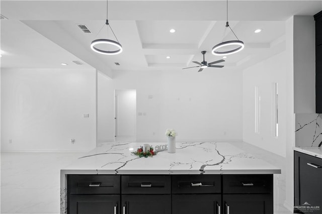 kitchen featuring hanging light fixtures, visible vents, and dark cabinets