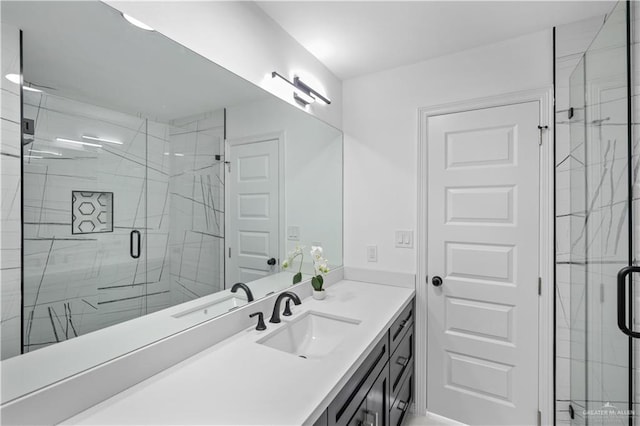 bathroom with a shower stall and vanity