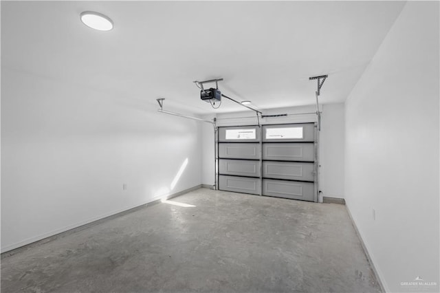 garage with a garage door opener and baseboards