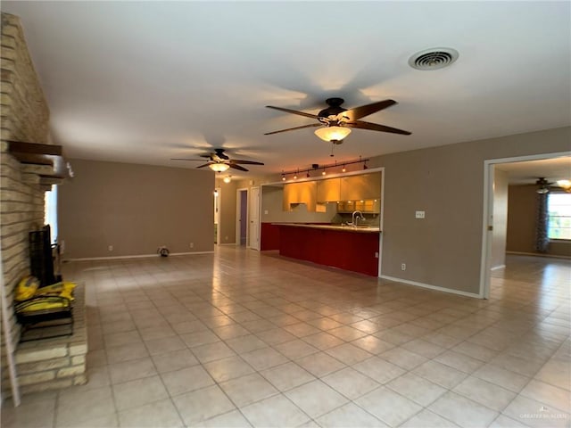 1802 N 17th St, Harlingen, TX 78550 - unfurnished living room featuring a ceiling fan, track lighting, and light tile patterned floors
