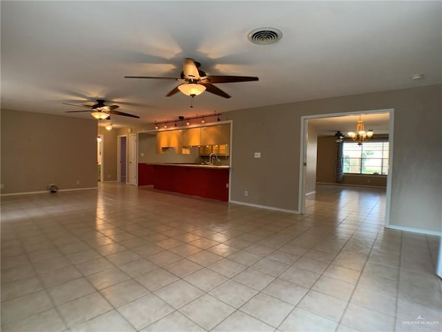 1802 N 17th St, Harlingen, TX 78550 - unfurnished living room with a chandelier, rail lighting, a ceiling fan, and light tile patterned floors