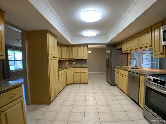 1802 N 17th St, Harlingen, TX 78550 - kitchen featuring appliances with stainless steel finishes, a raised ceiling, decorative backsplash, light tile patterned floors, and ornamental molding