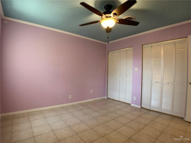 1802 N 17th St, Harlingen, TX 78550 - unfurnished bedroom with multiple closets, ornamental molding, and a ceiling fan