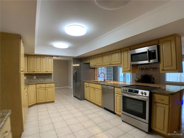 1802 N 17th St, Harlingen, TX 78550 - kitchen with appliances with stainless steel finishes, a tray ceiling, backsplash, crown molding, and dark stone countertops