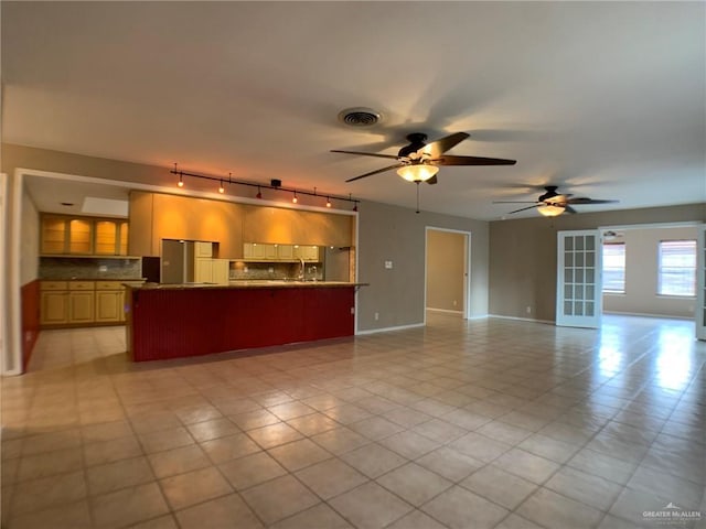 1802 N 17th St, Harlingen, TX 78550 - unfurnished living room featuring a ceiling fan, track lighting, and light tile patterned floors