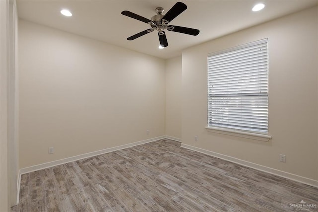 empty room featuring ceiling fan and light wood-type flooring