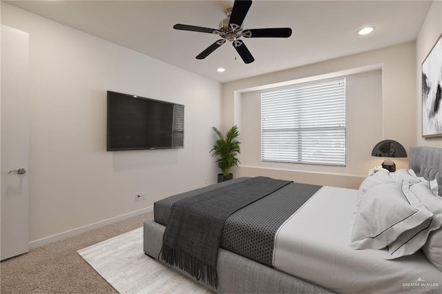 bedroom featuring light carpet and ceiling fan