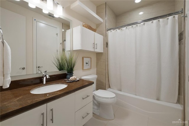 full bathroom with tile patterned flooring, vanity, toilet, and shower / bath combo with shower curtain