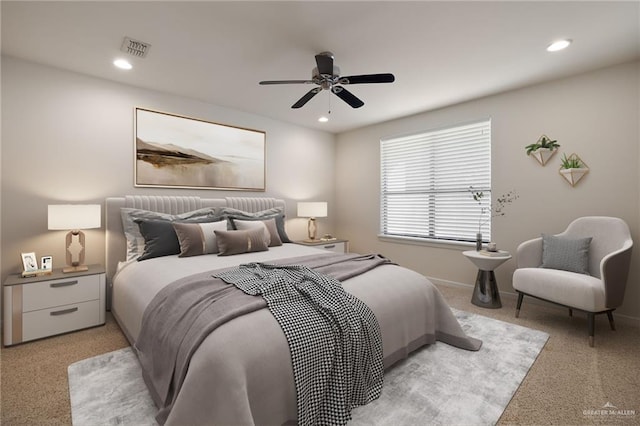 bedroom with ceiling fan and light carpet