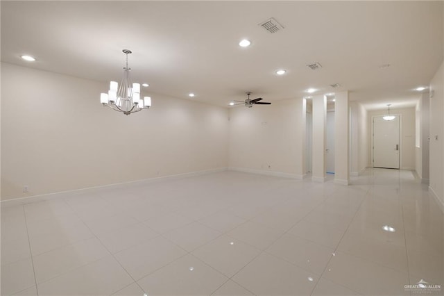 unfurnished room featuring light tile patterned flooring and ceiling fan with notable chandelier