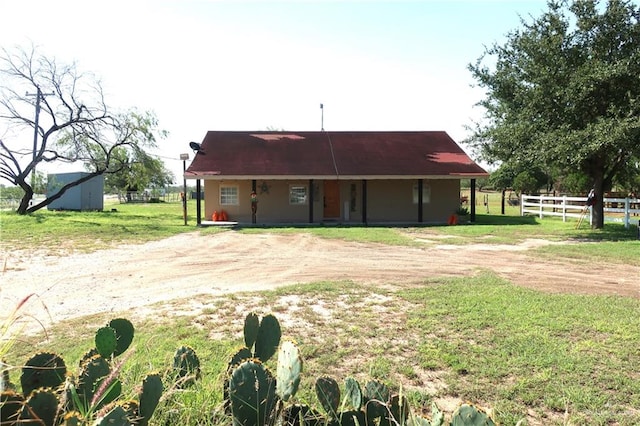 rear view of property featuring an outdoor structure