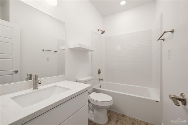 full bathroom featuring shower / washtub combination, vanity, wood-type flooring, and toilet