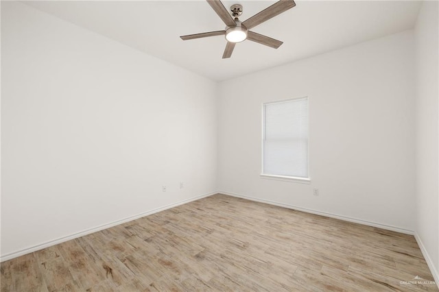 spare room featuring light hardwood / wood-style flooring and ceiling fan