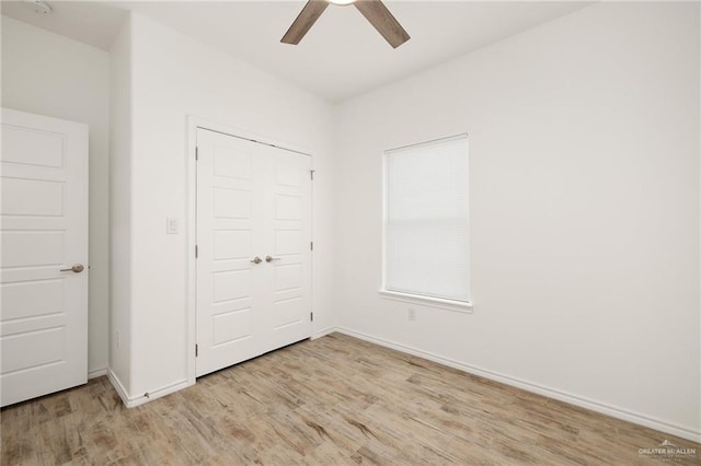 unfurnished bedroom featuring a closet, light hardwood / wood-style flooring, and ceiling fan