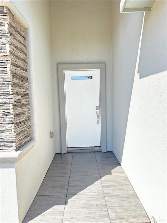 property entrance with stucco siding