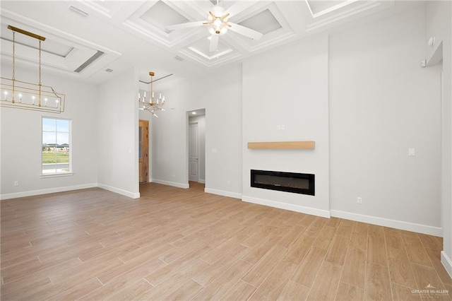 unfurnished living room featuring a high ceiling, coffered ceiling, light hardwood / wood-style floors, and beam ceiling