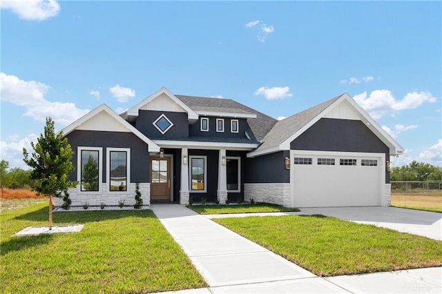 craftsman-style home featuring a garage and a front yard