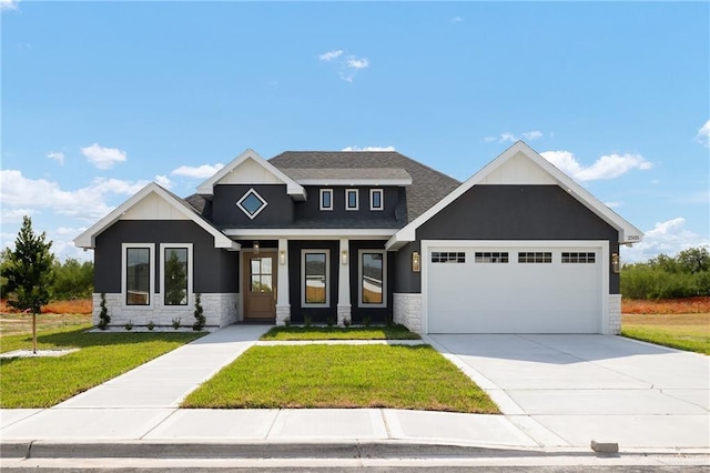 craftsman-style house featuring a garage and a front lawn