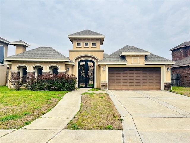 view of front of house with a garage and a front lawn