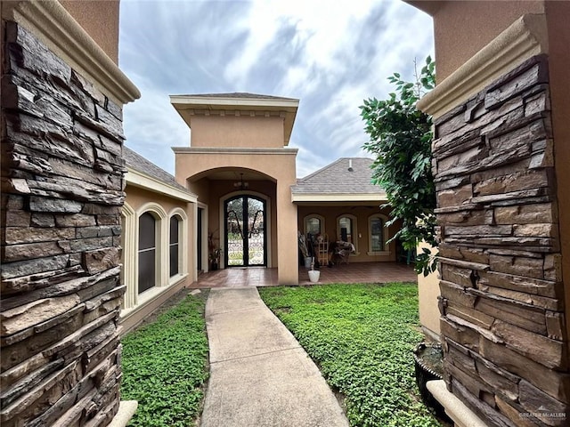 view of exterior entry with a lawn