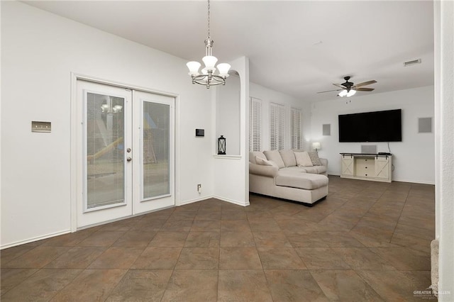 unfurnished living room with ceiling fan with notable chandelier and french doors