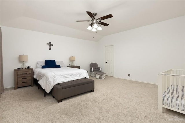 bedroom with ceiling fan, lofted ceiling, and light carpet