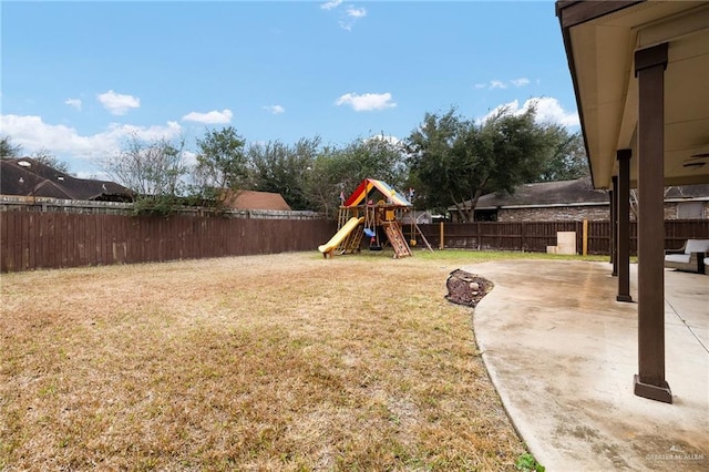 view of yard with a playground and a patio area